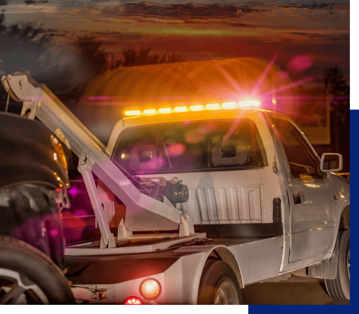 Tow truck at sunset with lights