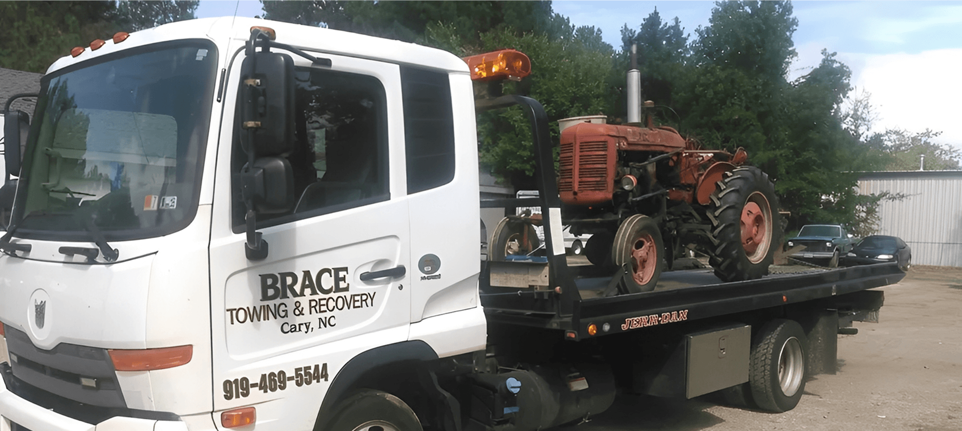 Vintage tractor on flatbed truck