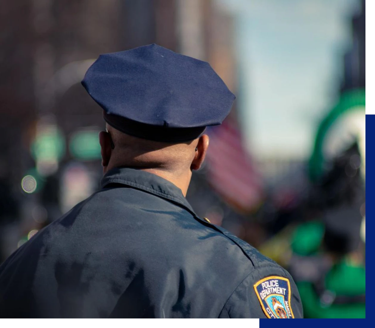 Police officer facing away in street scene
