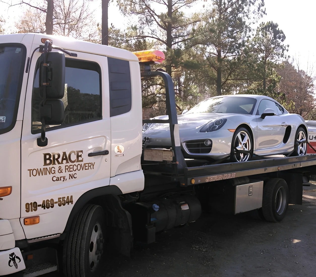 Tow truck transporting a sports car